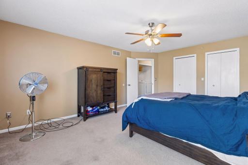 The primary bedroom is equipped with a ceiling fan for added comfort
