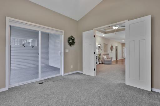 Sunroom with sliding glass door to covered porch