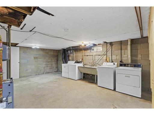 Shared laundry room for units 1 & 3, each unit has access to it from it's own lockable door. Back Door for Owner Storage/Supply Room