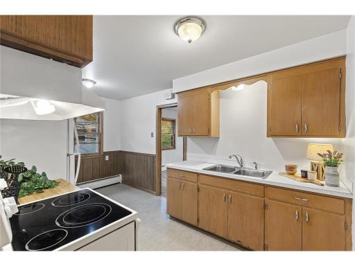Unit 2 kitchen with dining area with side windows leading into the Living Room