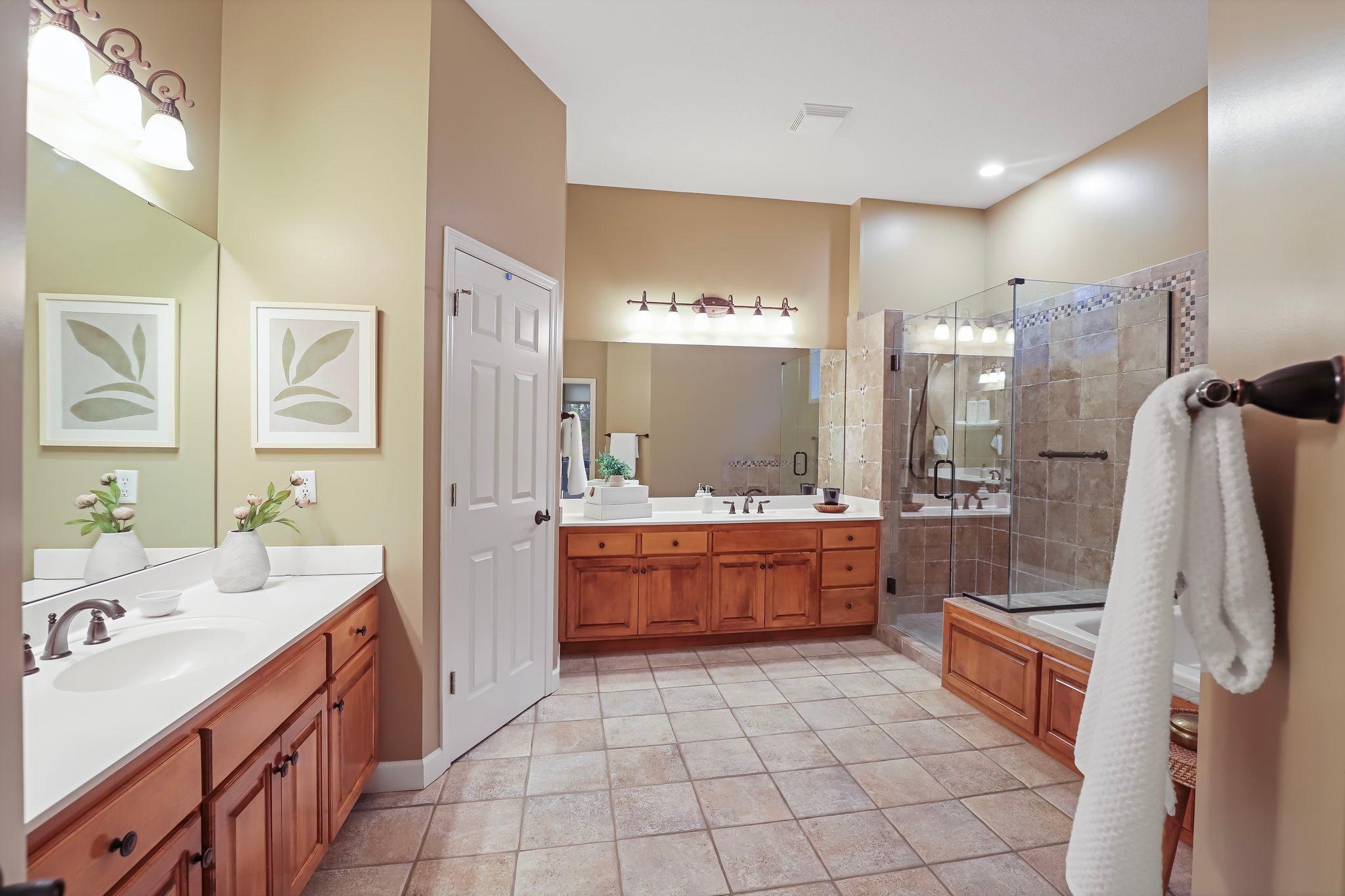 Large primary bathroom with two sink areas.