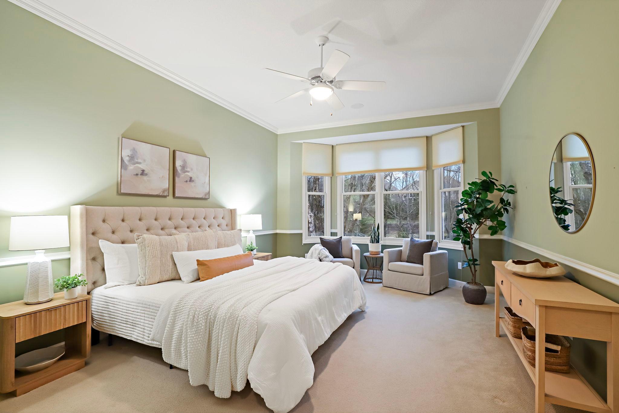 Primary suite with a large bay window.