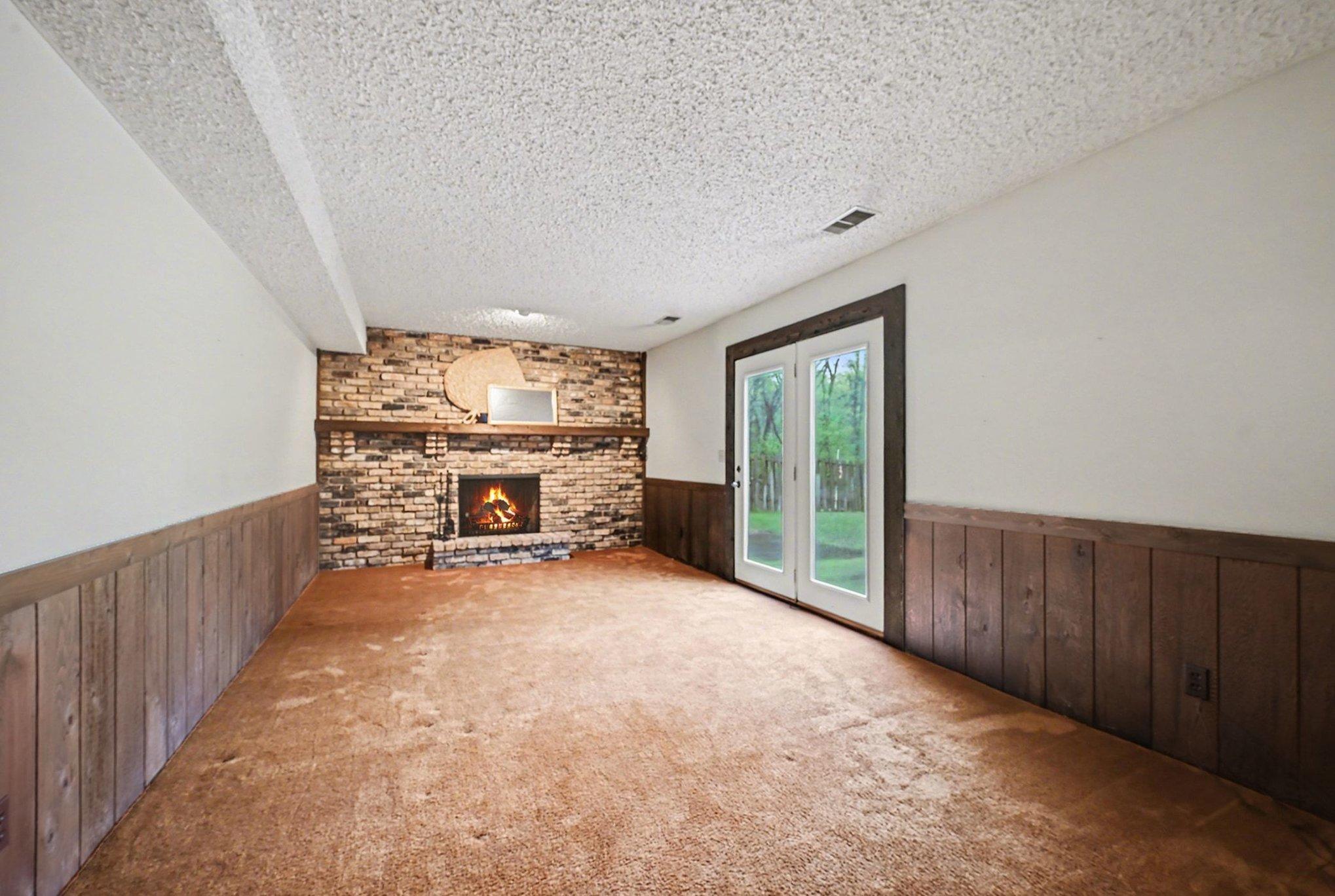 Lower level family room w/ wood burning fireplace