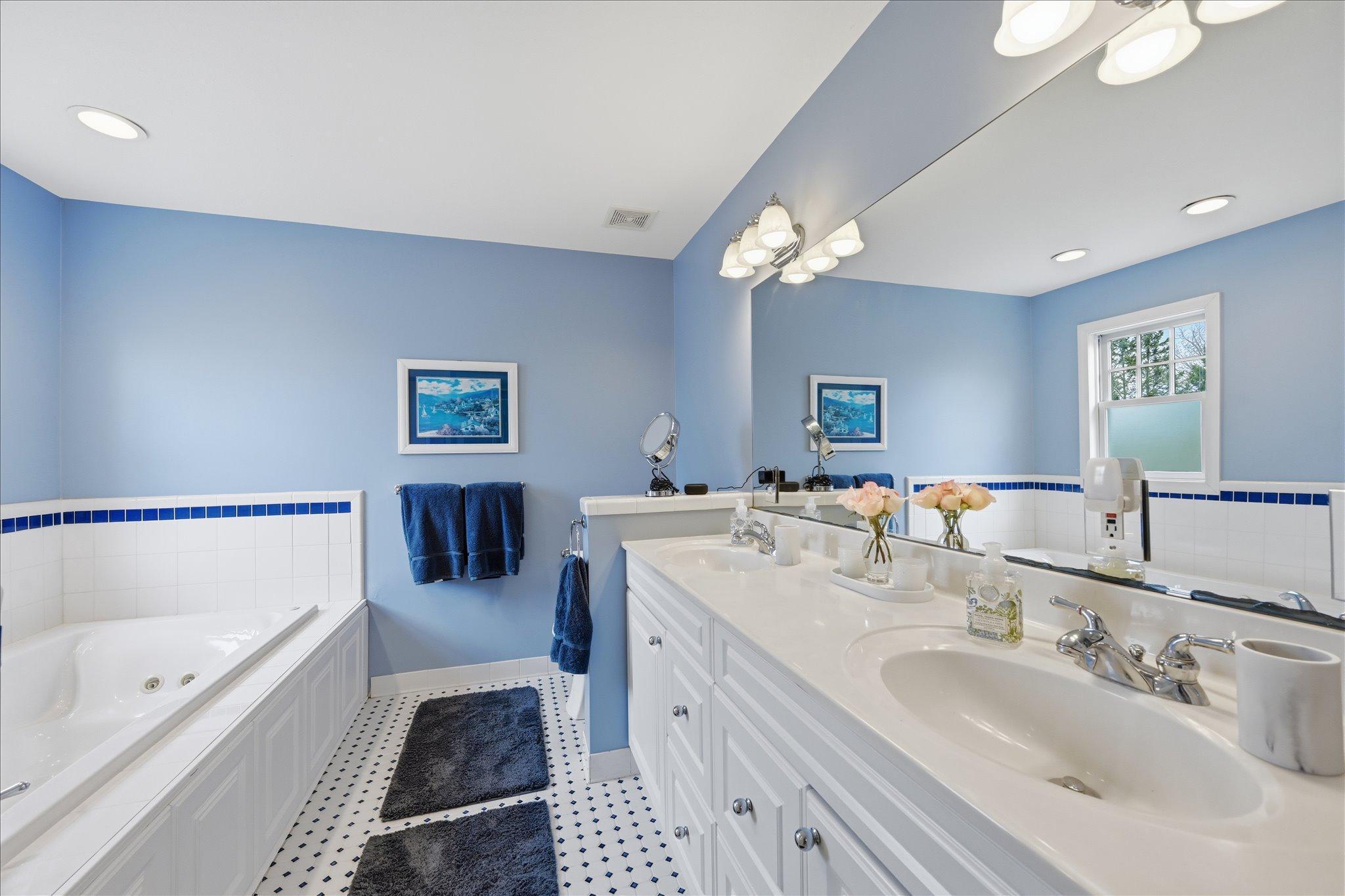 Primary ensuite with tile heated floors and jetted tub.