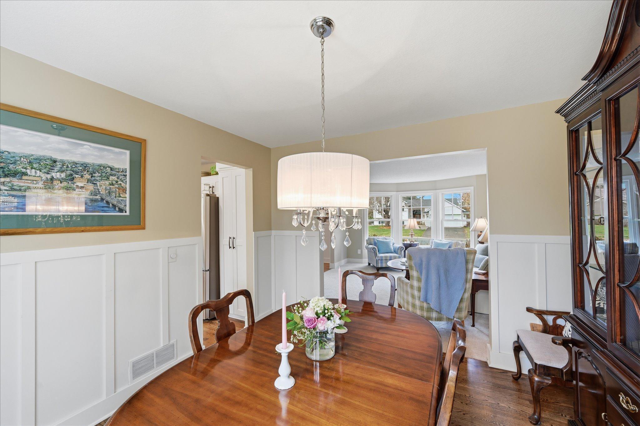 Formal dining room with baton board and wide opening into the living room.