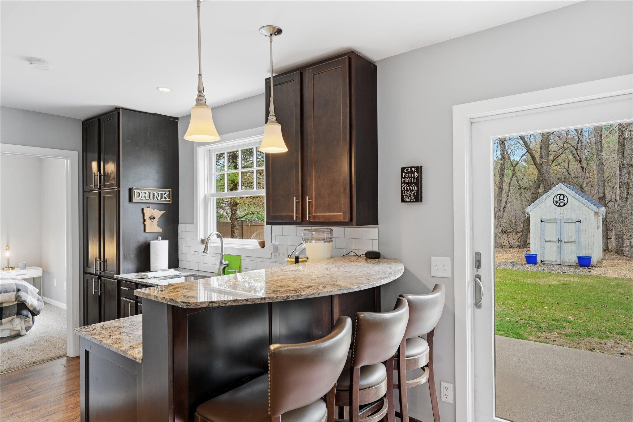 Wet Bar features cherry cabinetry, granite countertops and its own full sized refrigerator.