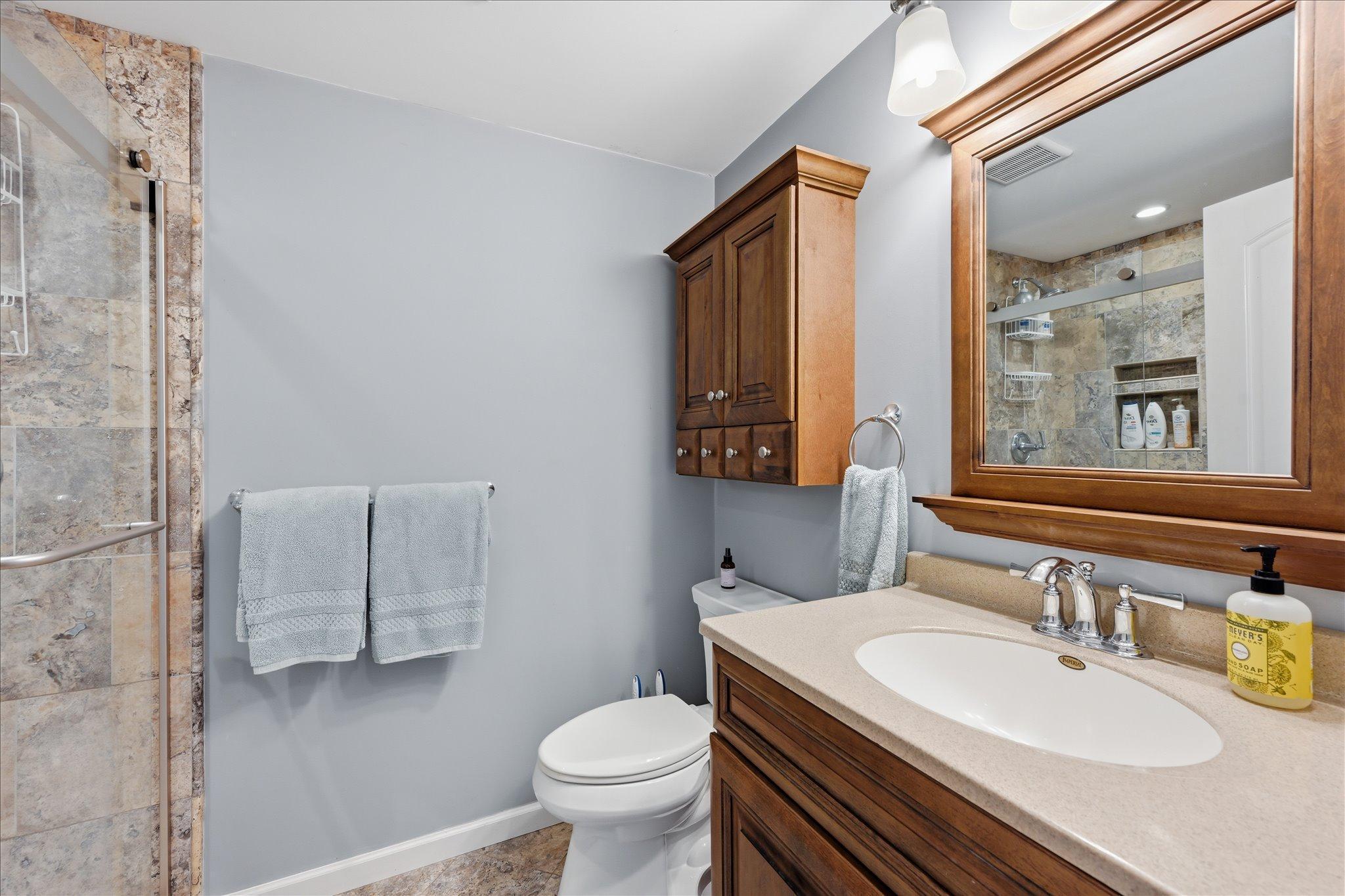 Basement 3/4 bath offers full Travertine tile!