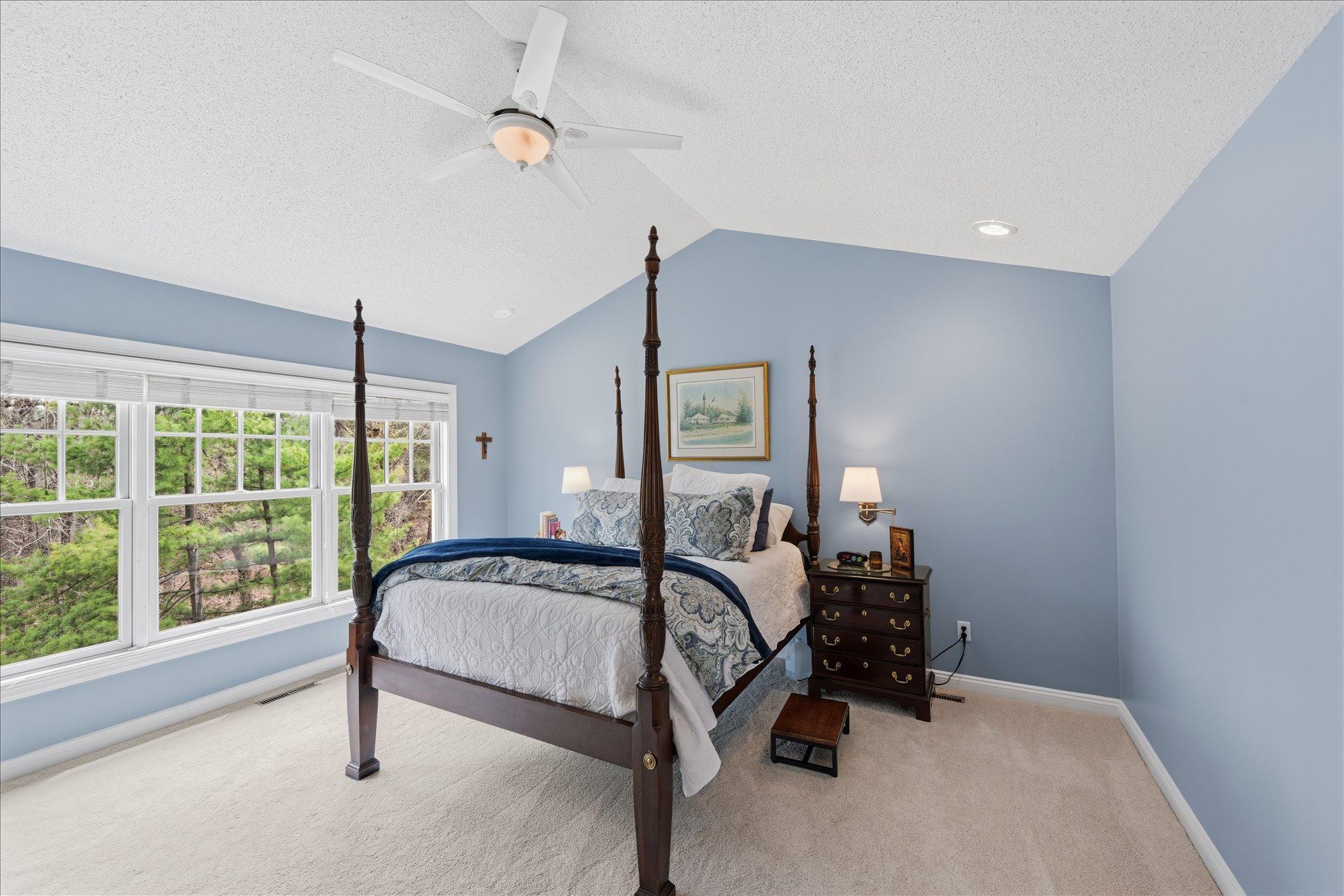 Primary suite with vaulted ceiling an oversized windows looking out over your VERY private backyard!