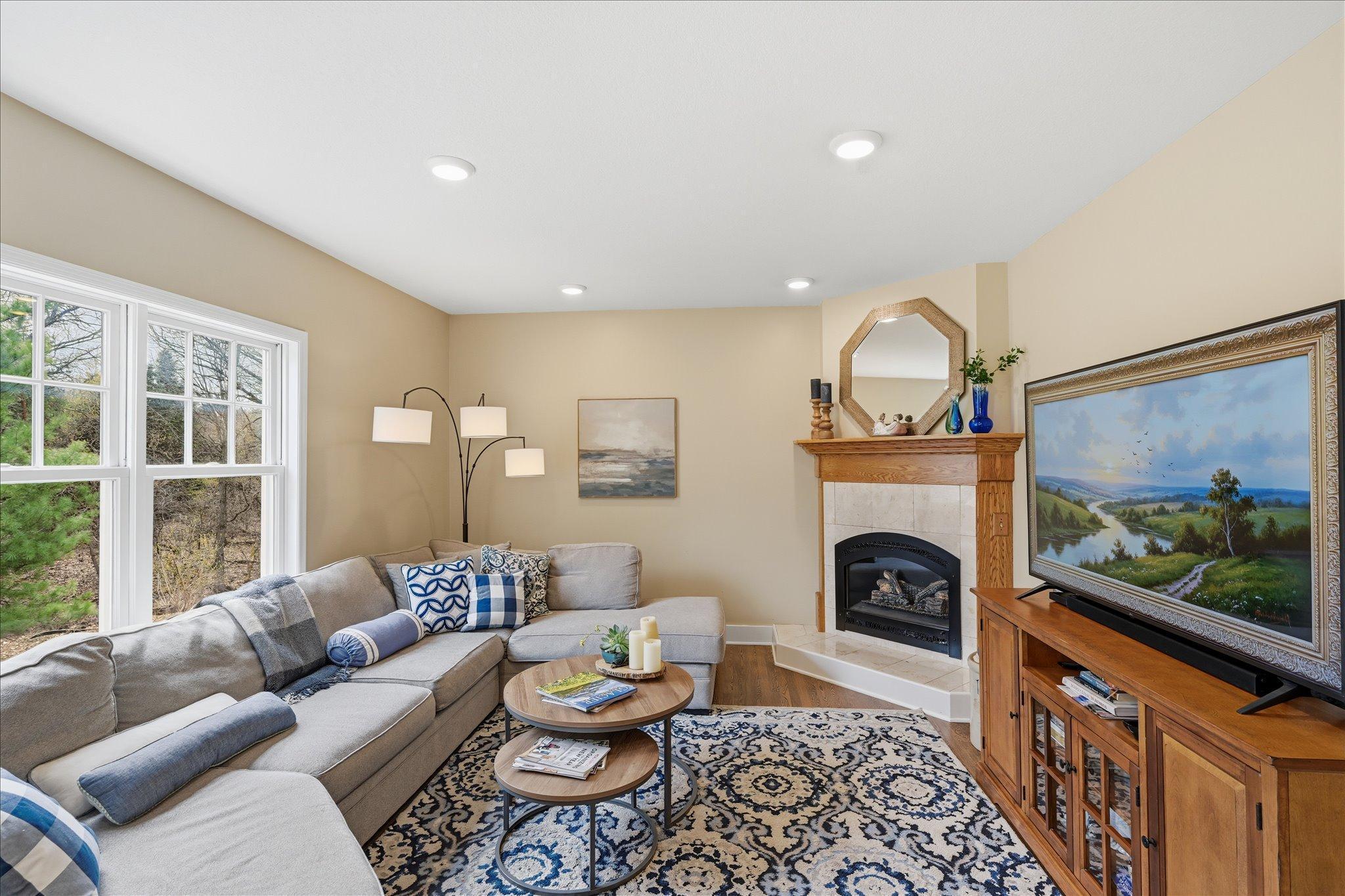 The back of the house faces southeast for tons of light through the large windows and the family room has a gas fireplace with tile surround.