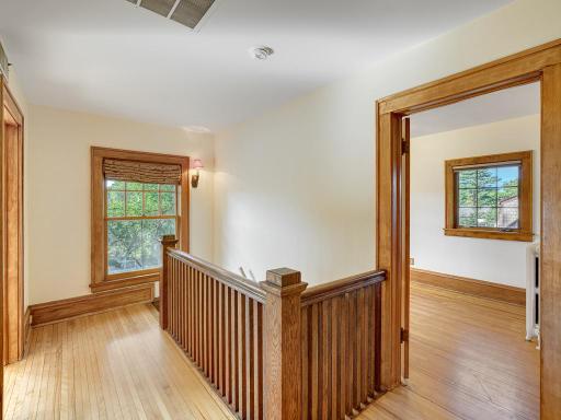 14 - Landing leading to 4 upstairs rooms. 3 bedrooms and a large sunroom which has been used as a 4th bedroom. Look at this rich natural woodwork!