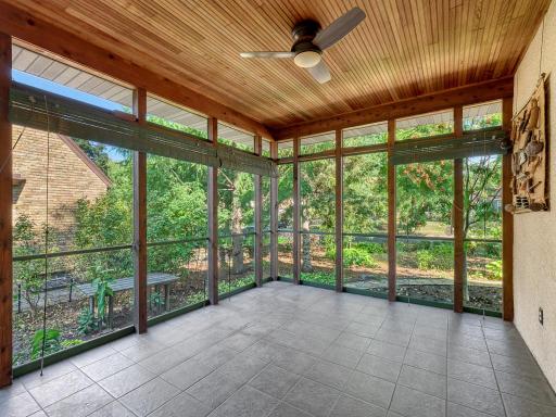 26 - Spend lazy summer days on this glorious screened-in porch. It opens conveniently from the kitchen and has plenty of space for dining and relaxing.