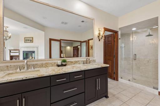 The spa-inspired primary bath features a beautifully tiled walk-in shower with timeless finishes.