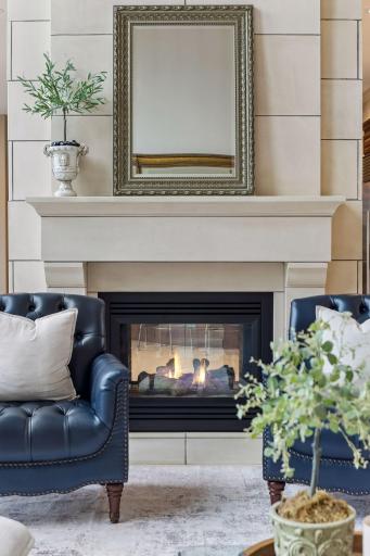 A striking see-through fireplace brings warmth and ambiance to both the kitchen and great room, elevating everyday living with a touch of luxury.