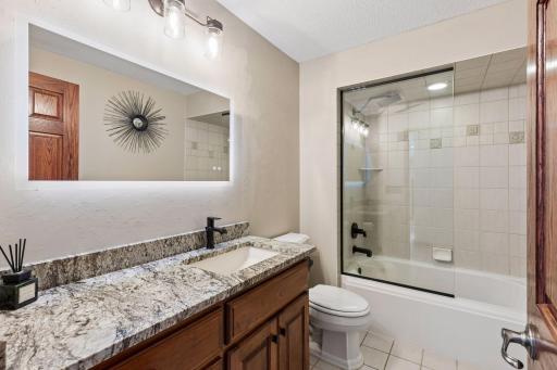 An upper-level full bath showcases spacious design and elegant finishes tailored for comfort and elevated everyday living.