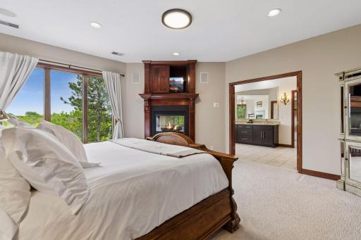Double doors open to a luxurious primary bath designed as a private spa-inspired retreat.