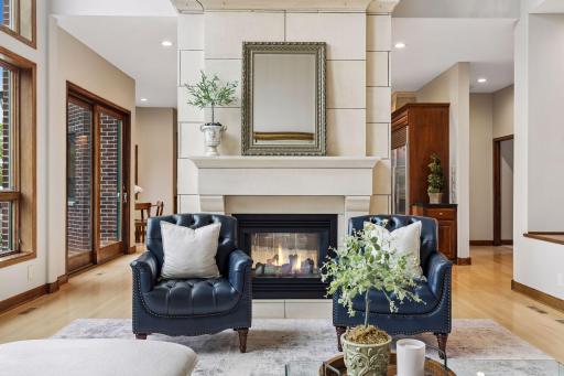 A striking see-through fireplace creates a warm and sophisticated atmosphere.