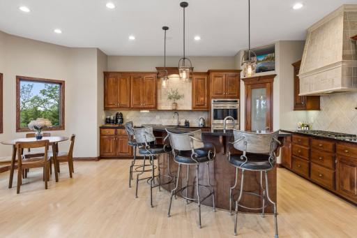 Custom cherry cabinetry, granite countertops, and professional-grade appliances create a kitchen as beautiful as it is functional.