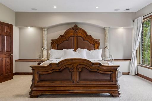 Architectural pillars and refined detailing elevate the luxurious primary suite.
