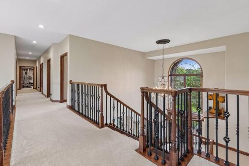 The dramatic upper-level catwalk overlooks both the grand entry and soaring great room.