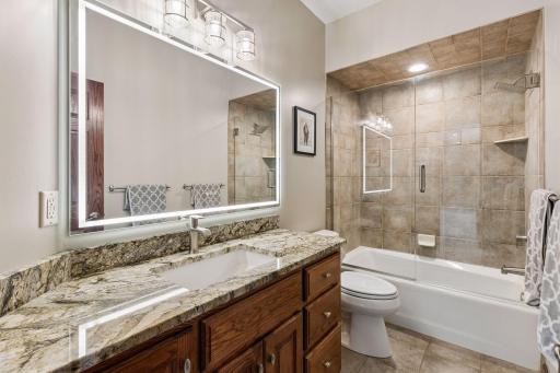 A beautifully designed main-level full bath with a smart mirror offers guests a sophisticated and elevated experience.