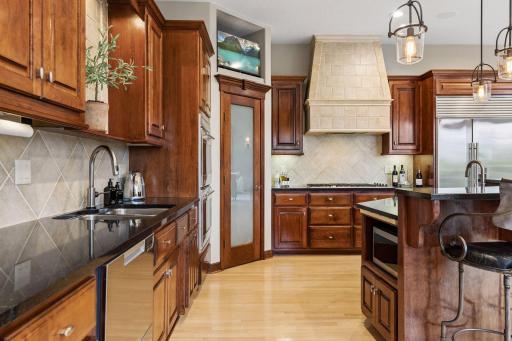 A spacious corner walk-in pantry offers exceptional storage.