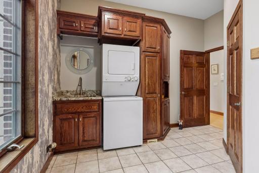 The thoughtfully designed mudroom features custom cabinetry and a main-level laundry area, creating a seamless transition from the four-stall garage while keeping everyday living effortlessly refined.