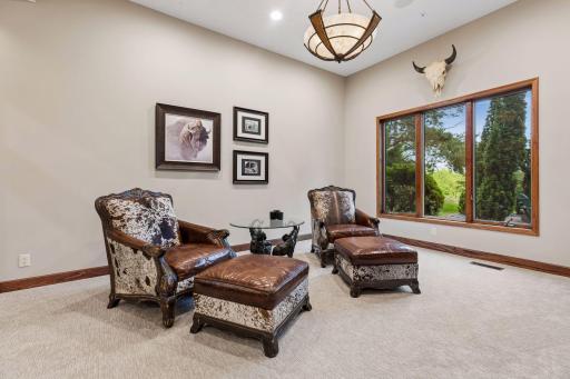 A sophisticated sitting room centered around the stunning see-through fireplace.
