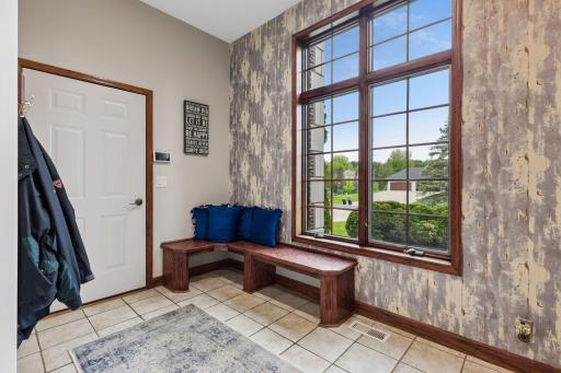 A light-filled mudroom just off the expansive four-stall garage combines everyday functionality with elevated design and welcoming warmth.