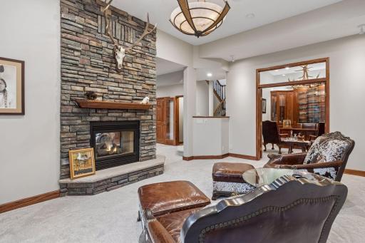 Beyond the sitting room, a grand private office offers an impressive space for productivity, creativity, and refined work-from-home living.