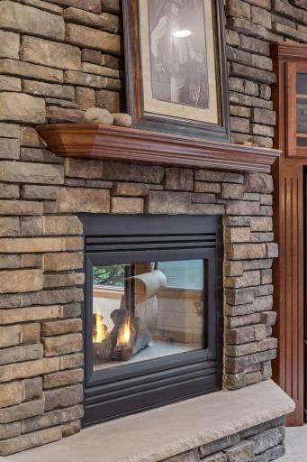 Yet another stunning see-through fireplace adds warmth, ambiance, and an elegant touch to the beautifully finished lower level.