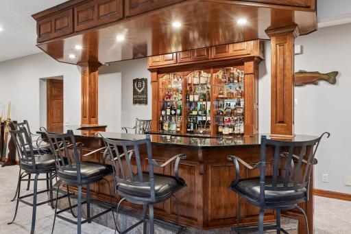 A refined wet bar with a mirrored liquor display creates the perfect setting for elevated entertaining and sophisticated evenings at home.