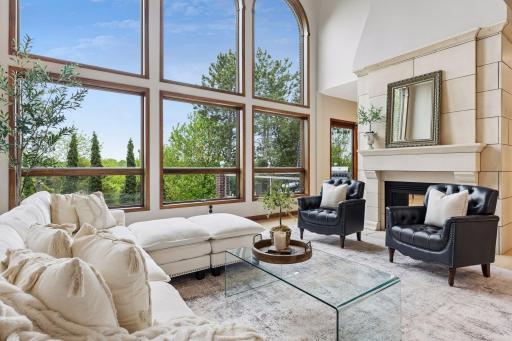 Grand in scale yet warm in feel, this stunning great room is filled with sunlight and framed by dramatic walls of windows.