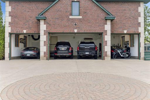 An expansive four-stall garage offers exceptional space for vehicles, storage, and elevated convenience.