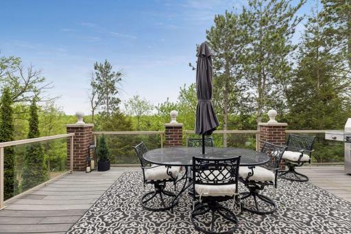 The glass-paneled deck creates the perfect setting for morning coffee, sunset gatherings, and quiet moments immersed in nature.