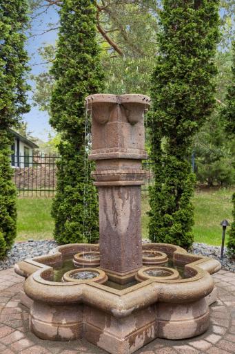 The tranquil fountain adds a serene ambiance to the outdoor living space.