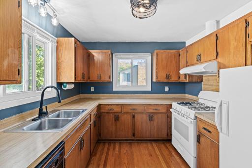 The kitchen features rich wooden cabinetry with plenty of storage/prep space!