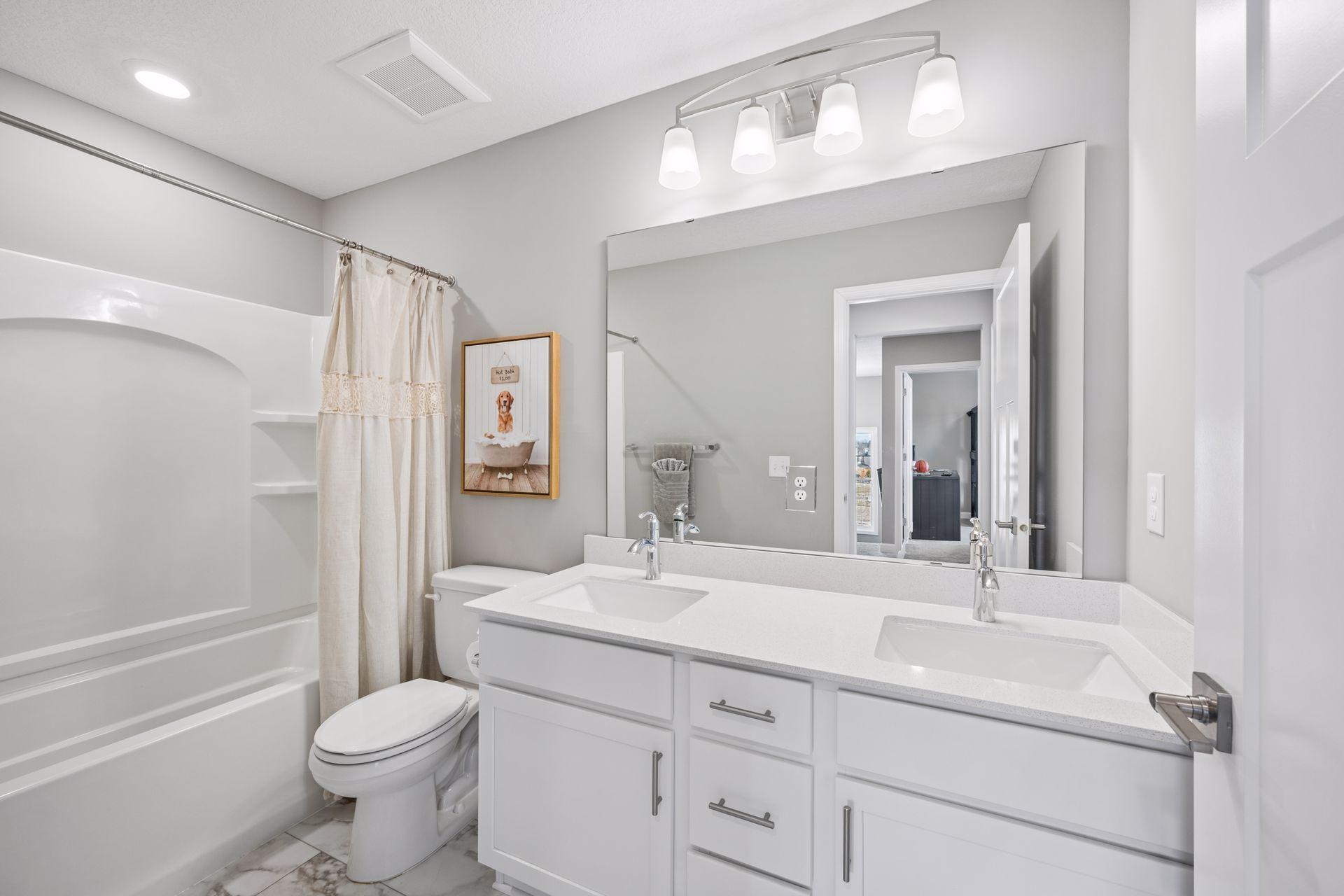 Upstairs full bathroom with double sinks