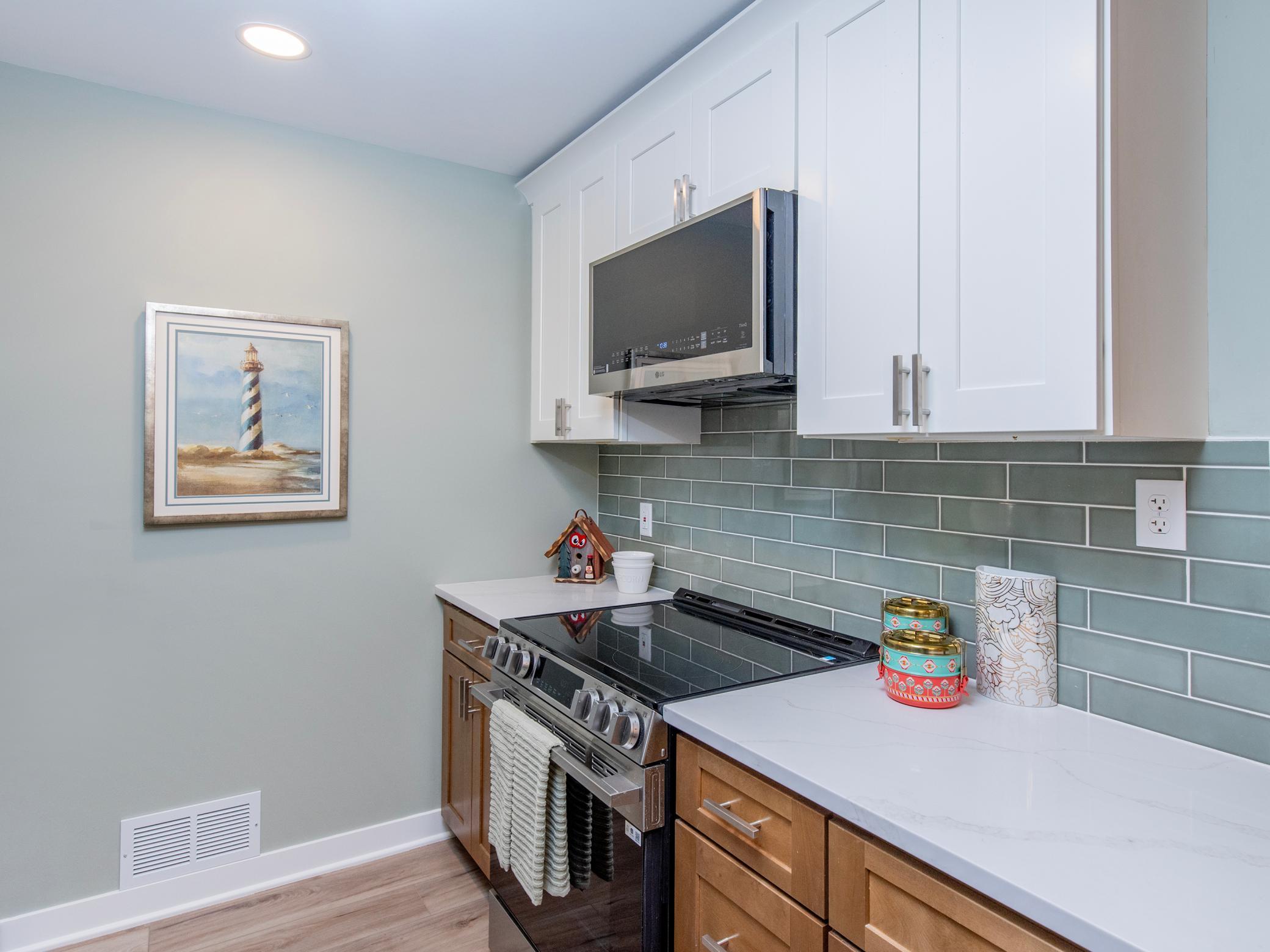 All new kitchen with soft close, solid wood plywood construction cupboards, porcelain subway backsplash, and quartz countertops.