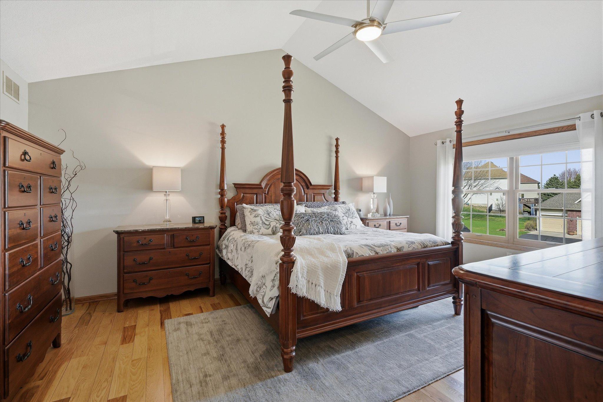 Updated Hickory flooring and a vaulted ceiling in the primary suite.