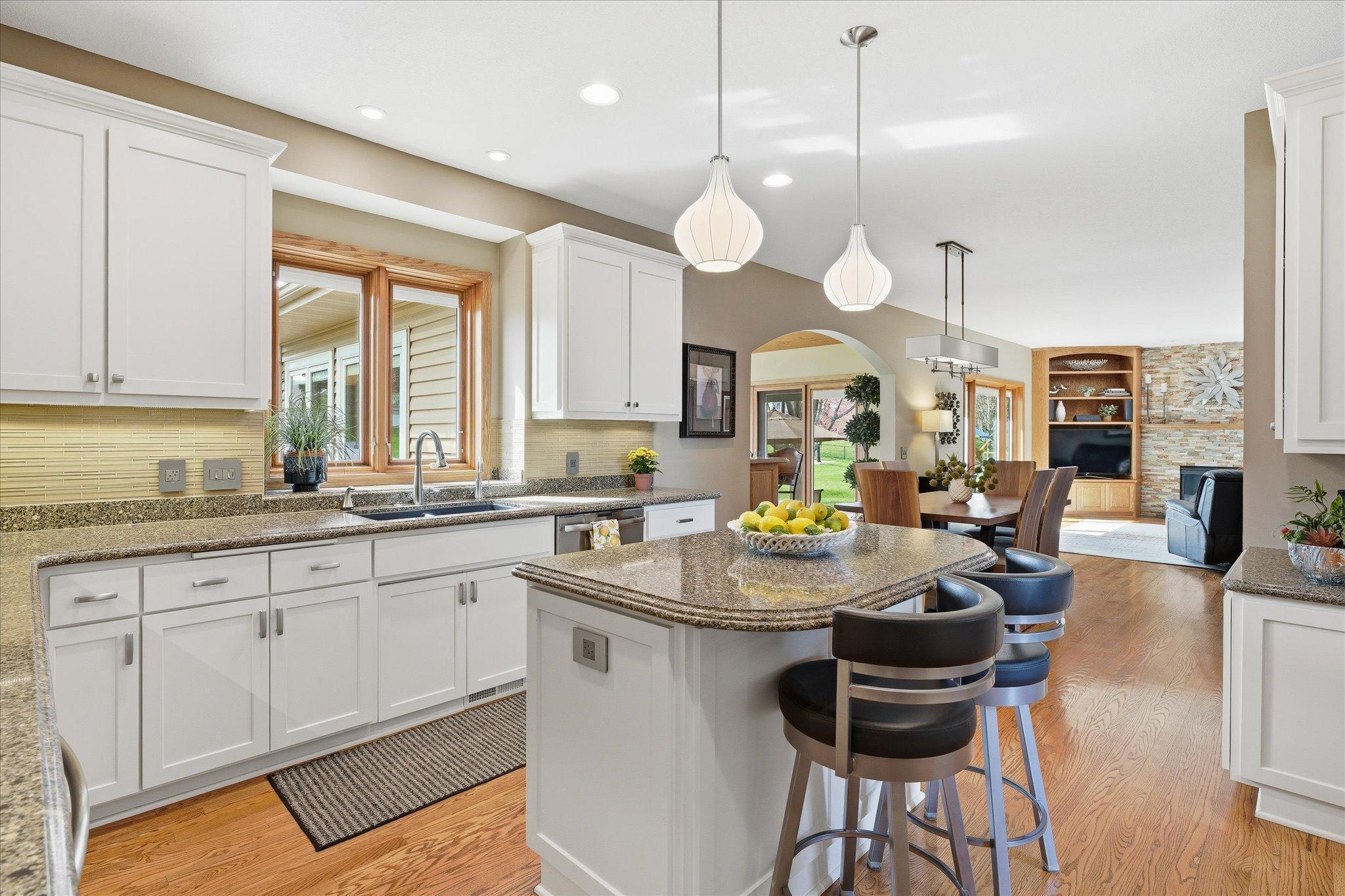 The remodeled kitchen features enameled custom cabinetry, stainless steel appliances, and Cambria countertops.