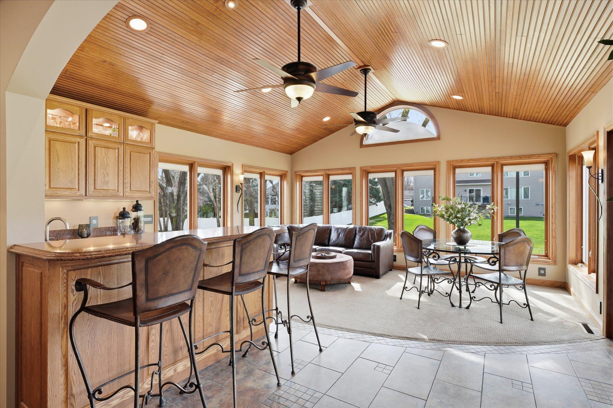 The stunning porch—complete with a wet bar with Cambria countertops—offers the perfect space to relax or entertain and walks out to a stamped concrete patio and backyard fire pit.