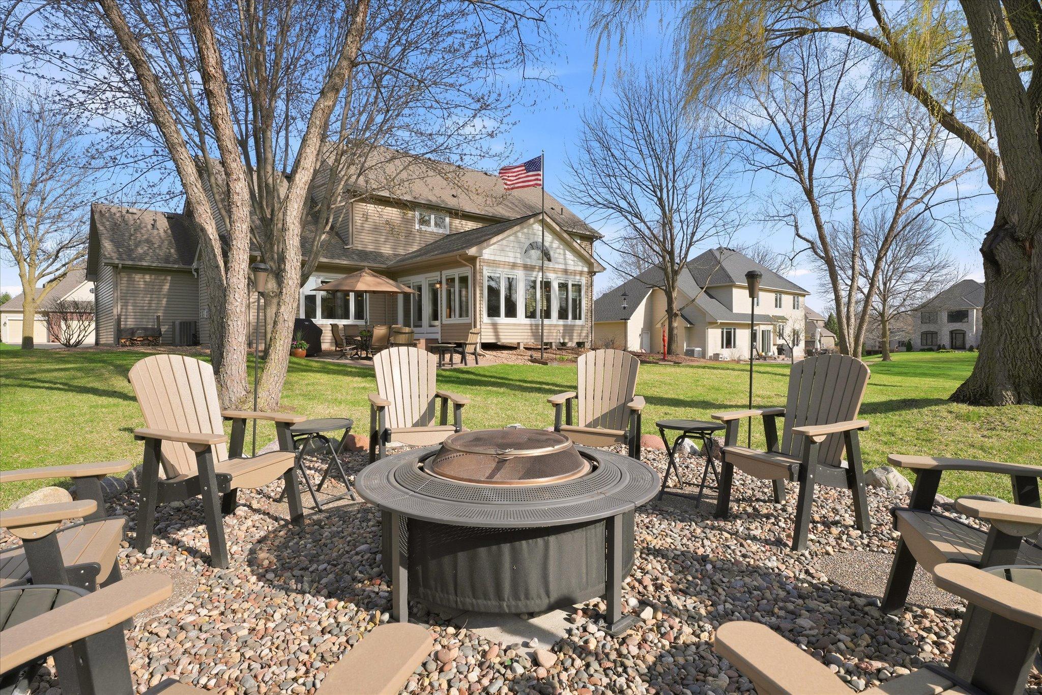 Enjoy the outdoors in the well designed and thoughtfully landscaped backyard with mature trees, stamped concrete patio and a firepit.