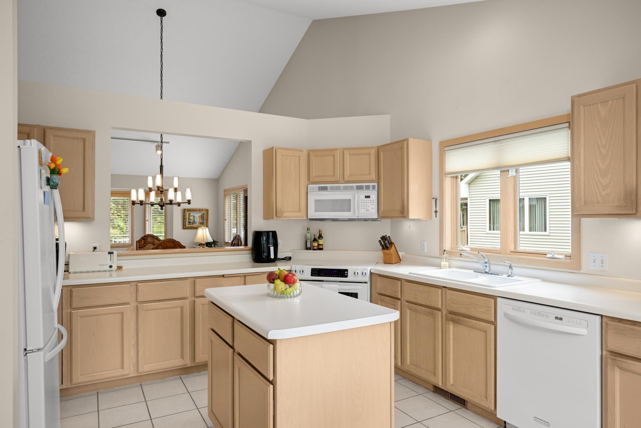 The center Island kitchen offers an eastern exposure window over the sink and a pass-through to the dining room