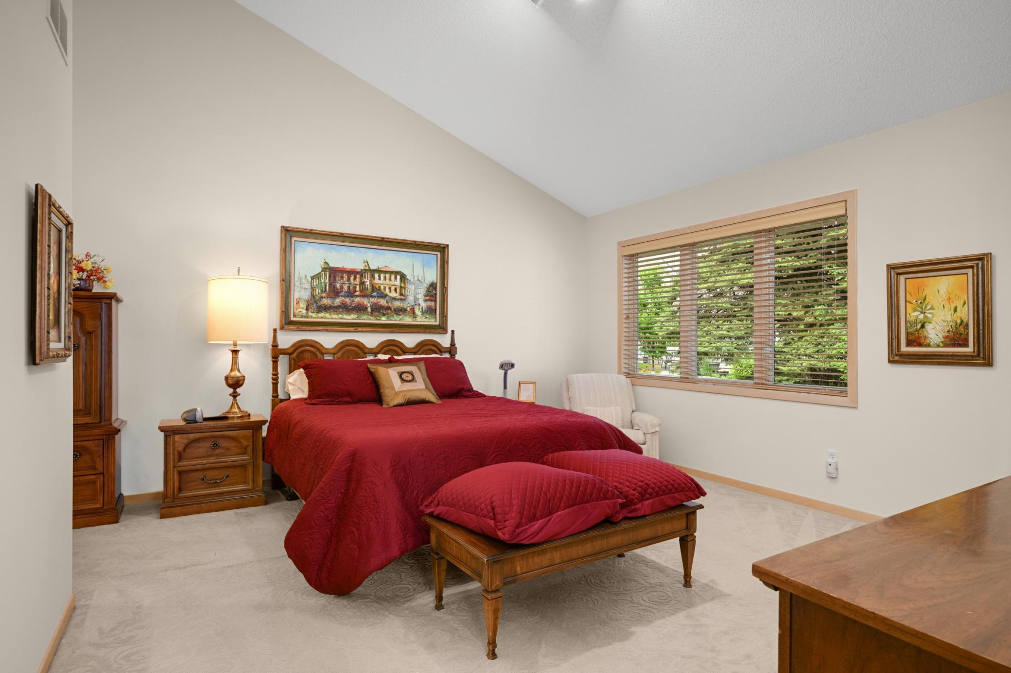 The primary suite on the main floor features a vaulted ceiling, a large walk-in closet