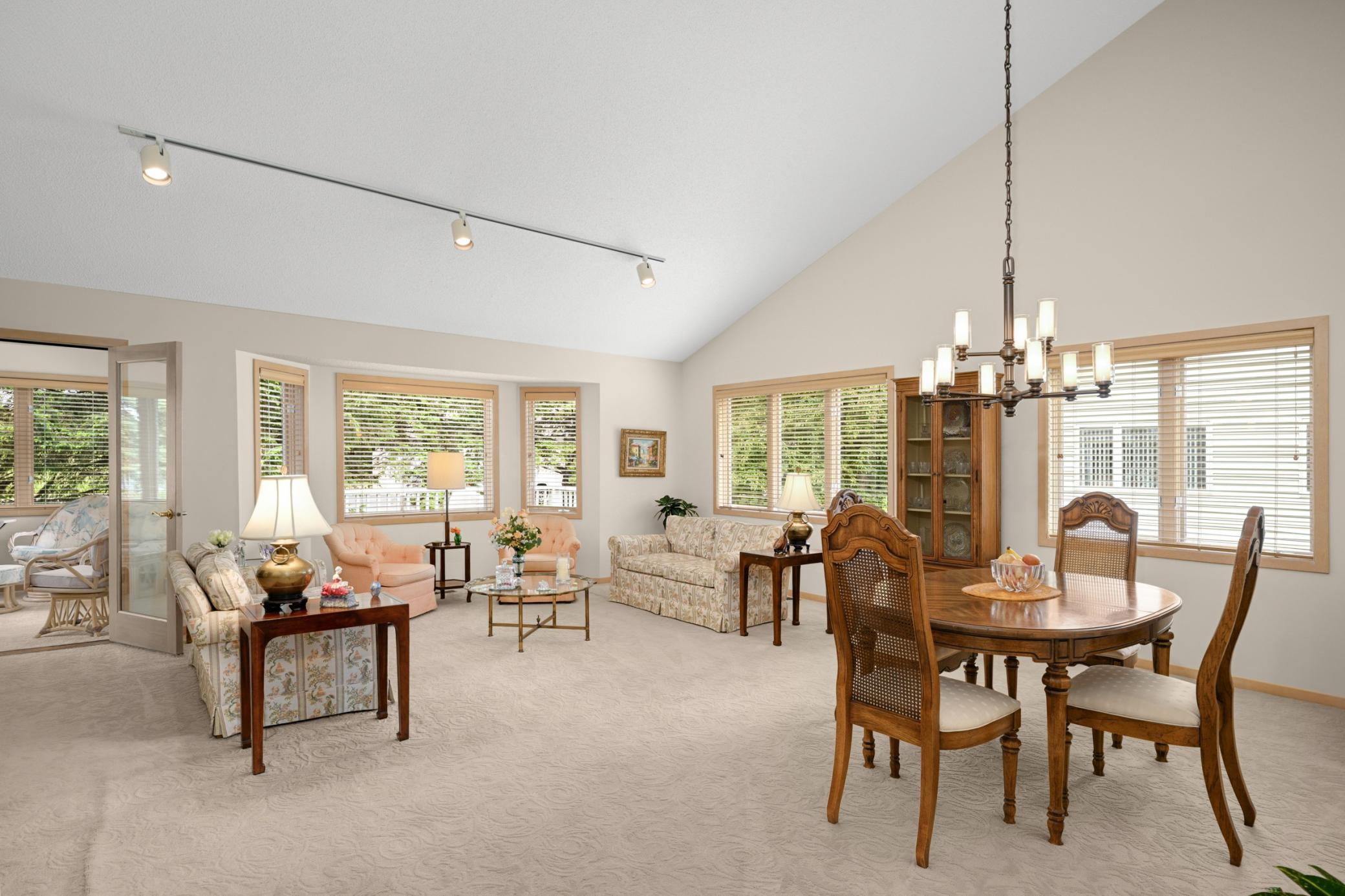 The spacious living and dining room has a vaulted ceiling, a large bay window and is ready for your new flooring touches.