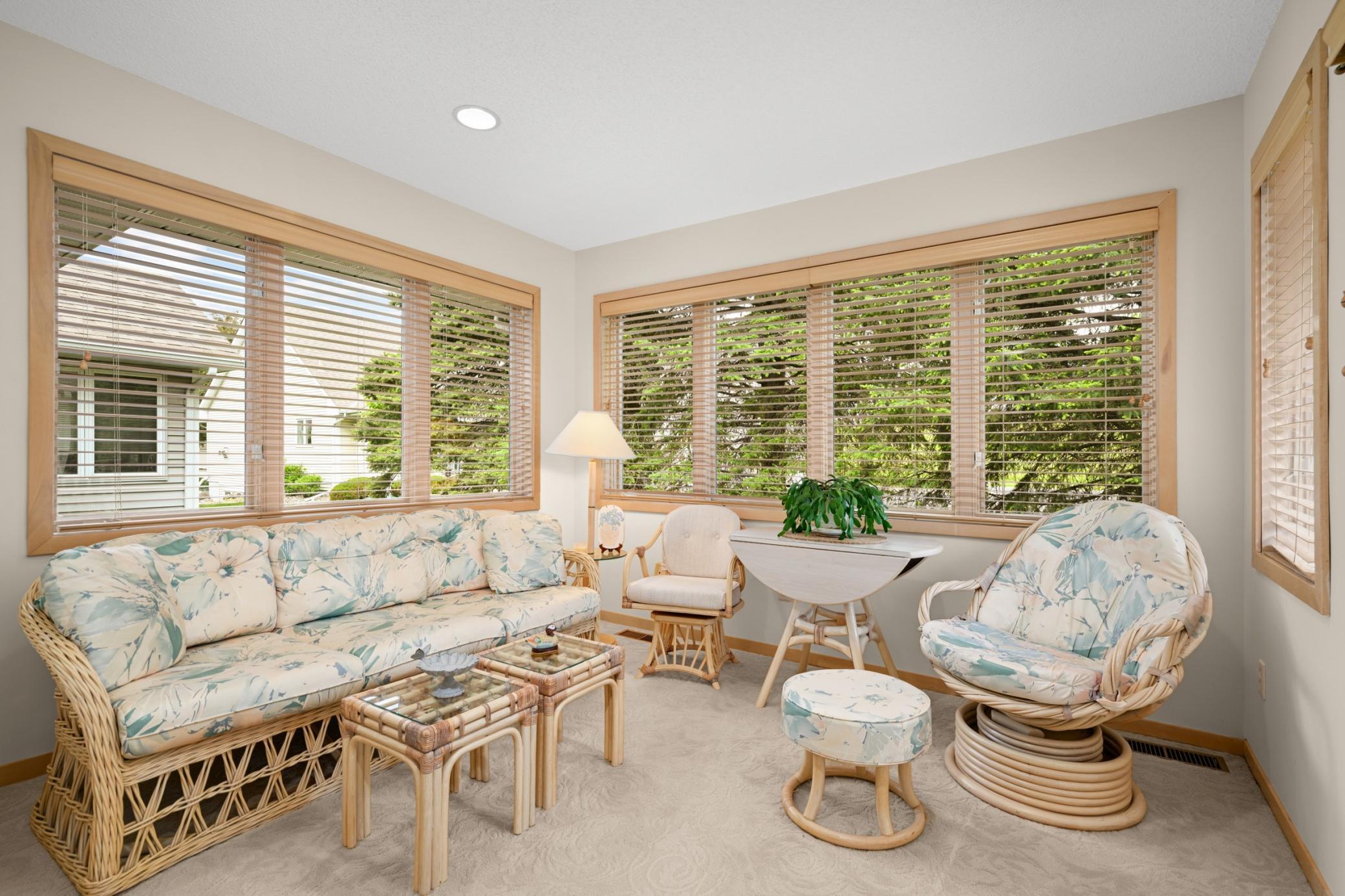 the 4 season sunroom is a great escape and is loaded with windows door to the deck