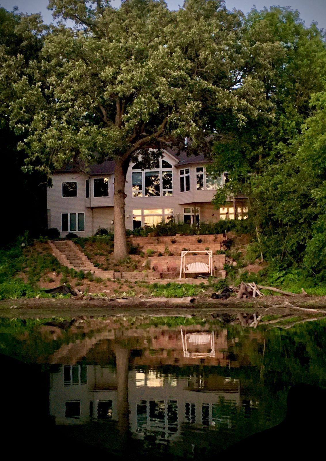 The gently sloping yard leads to a charming seating area—perfect for morning coffee, evening relaxation, or simply taking in the beauty of nature.