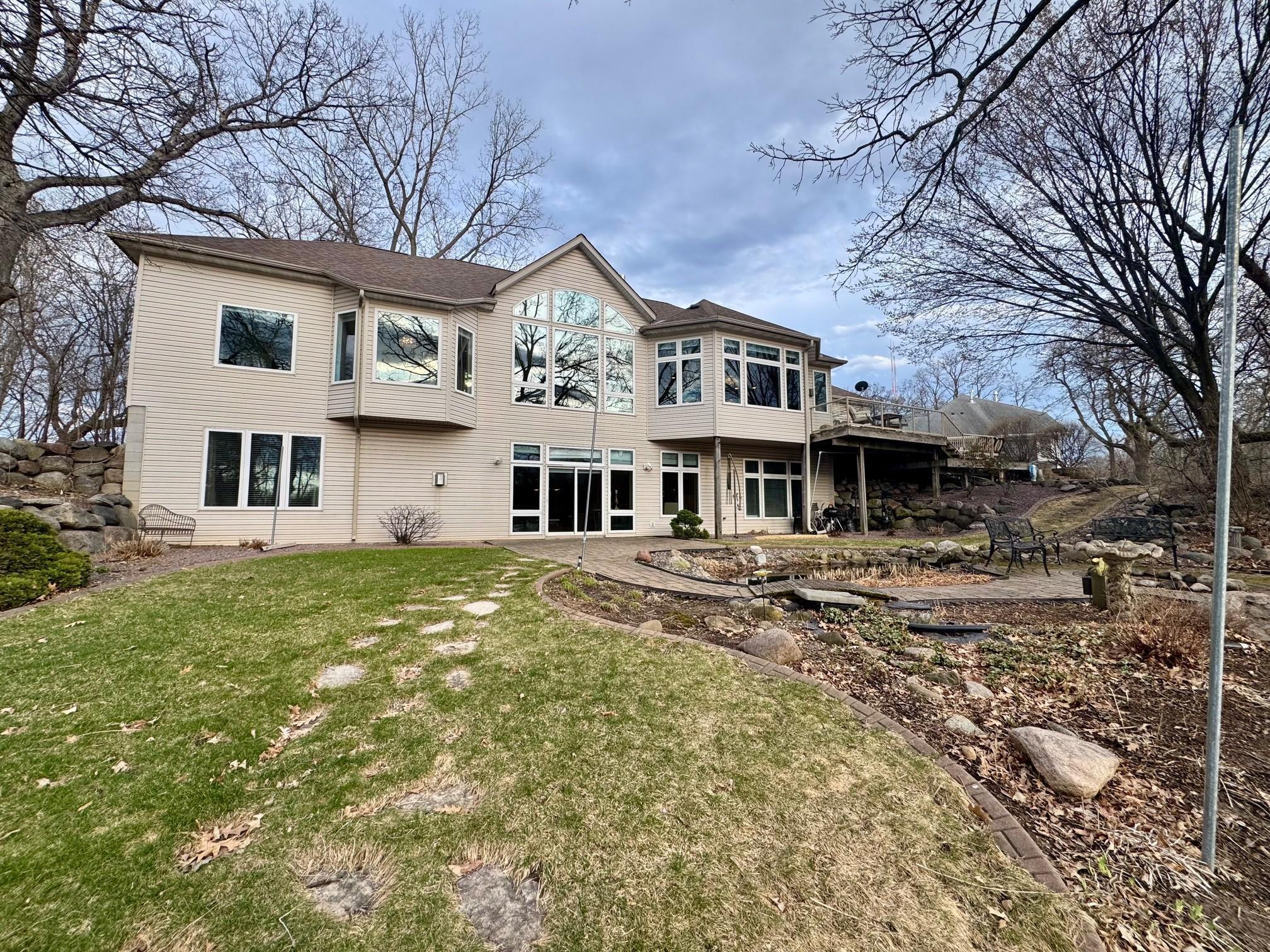 A rear view of the home. A walkout lower level leading to a large paver patio and a perfect place to relax or entertain.
