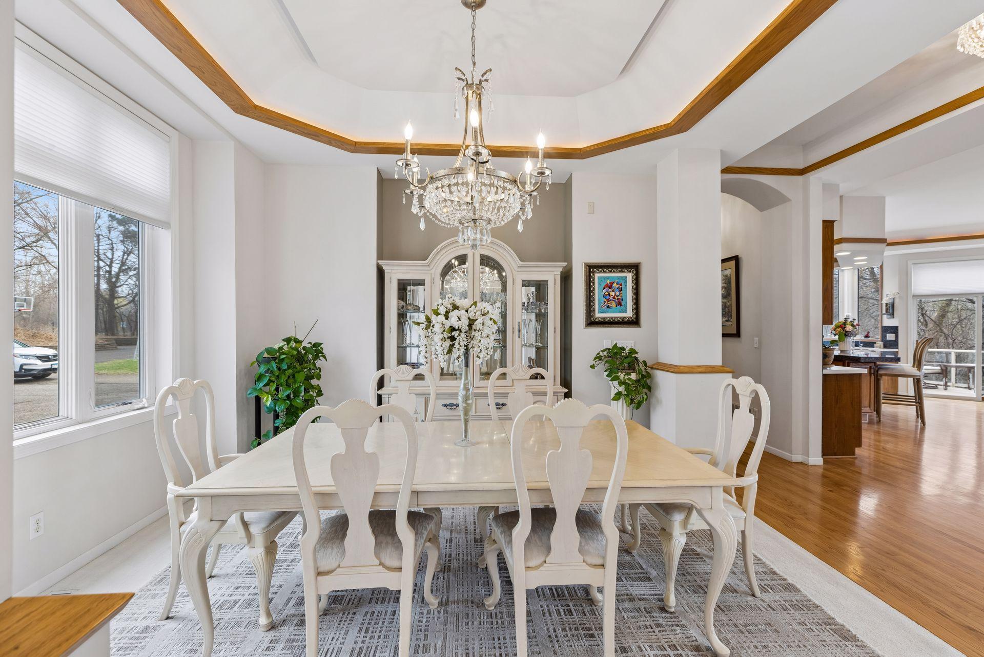 The adjacent dining space flows seamlessly from the foyer, offering an ideal setting for both everyday living and formal gatherings.