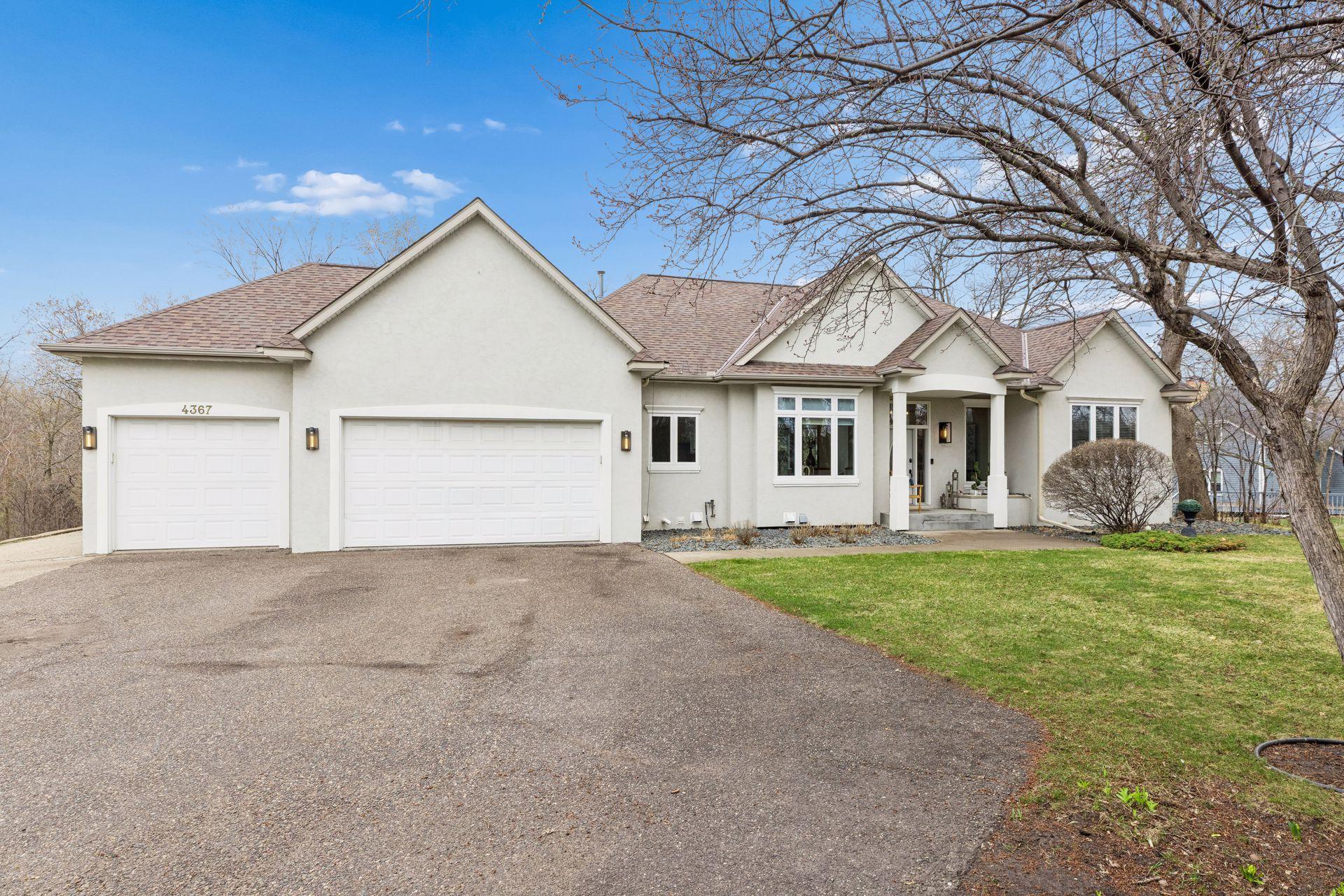A spacious three-car garage offers convenience and flexibility, while the clean architectural lines and neutral exterior provide a classic, move-in ready appearance.